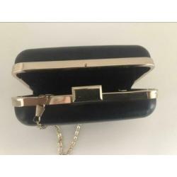 Black clutch bag with gold trim, 212 VIP by Carolina Herrera